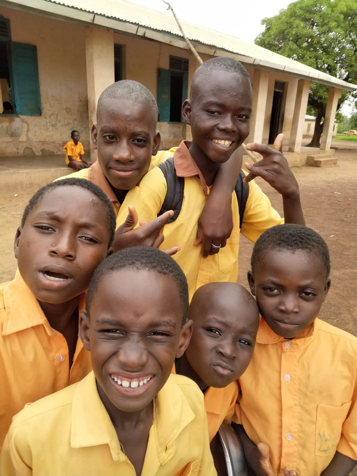 Students smiling together after receiving school supplies to support their learning.