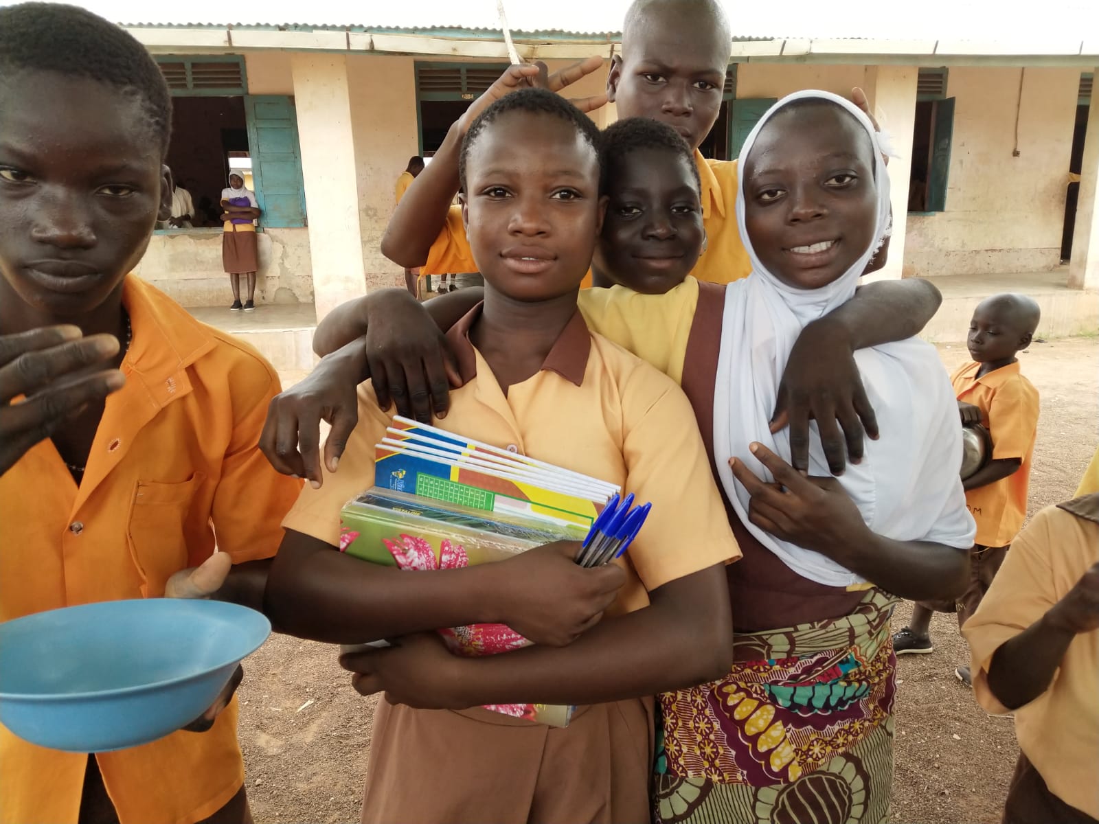 Students gathered at school with learning materials and school supplies.
