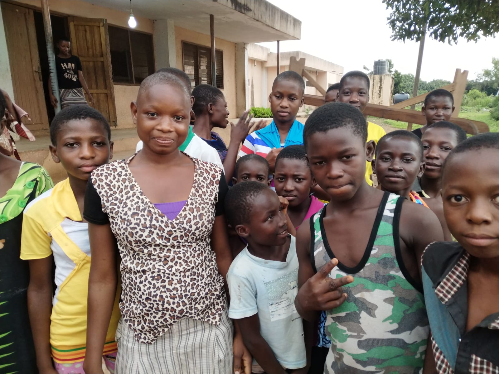 Students standing together at school after receiving learning support and supplies.